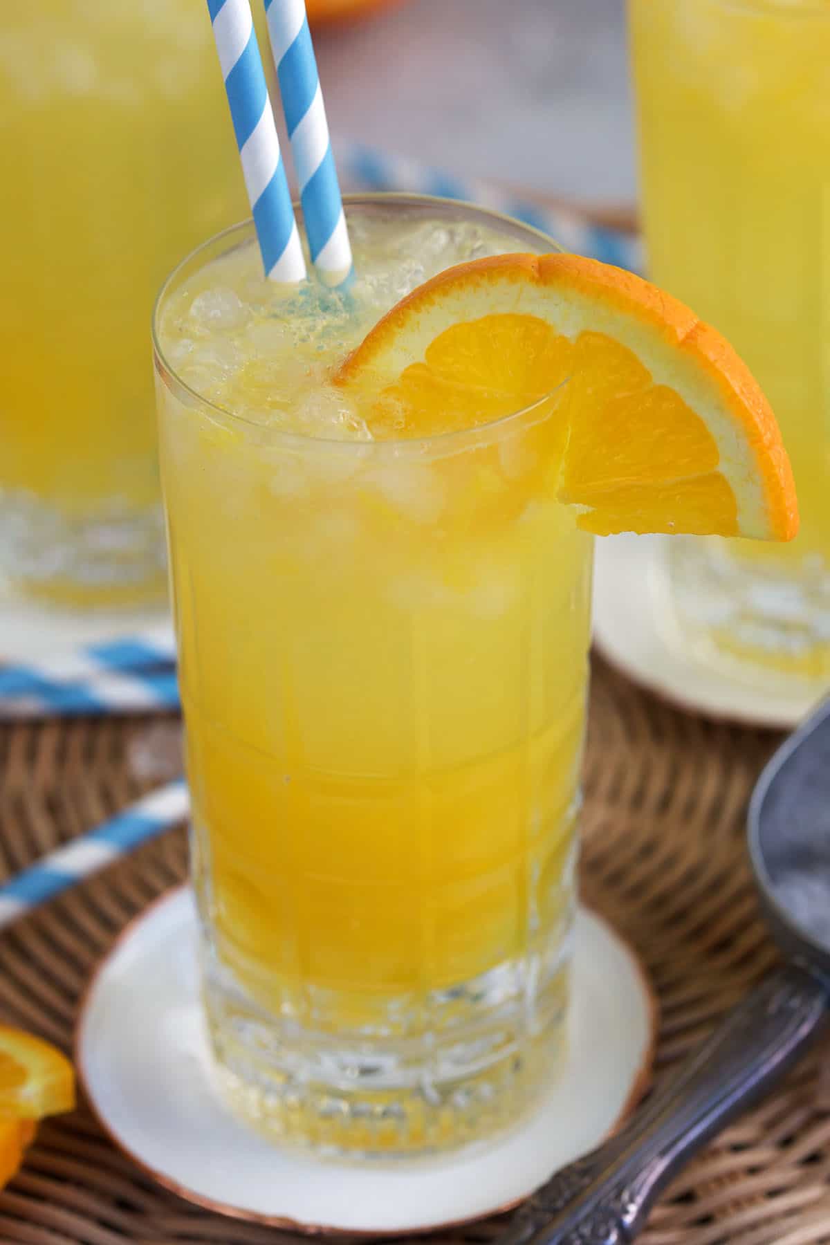 Orange Crush in a tall glass with an orange slice garnishing it.