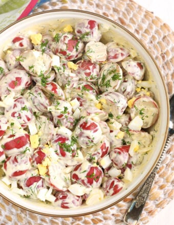 A bowl of red potato salad is full.