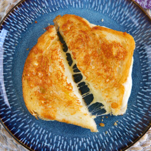 Grilled Cheese Sandwich on a blue plate.