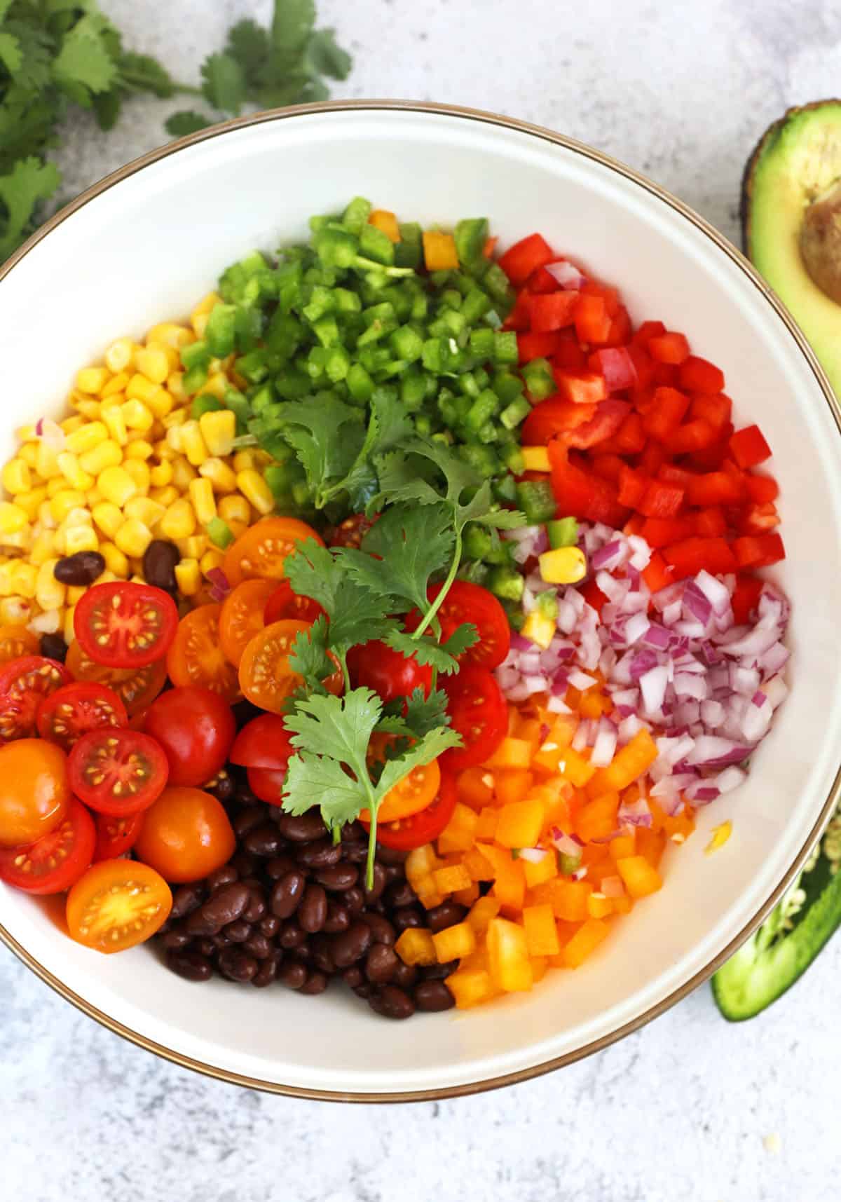 Overhead view of ingredients for black bean and corn salad in mixing bowl