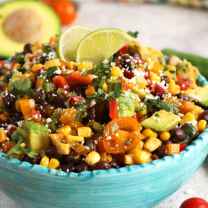 Black bean salad in serving bowl with lime wedges for garnish