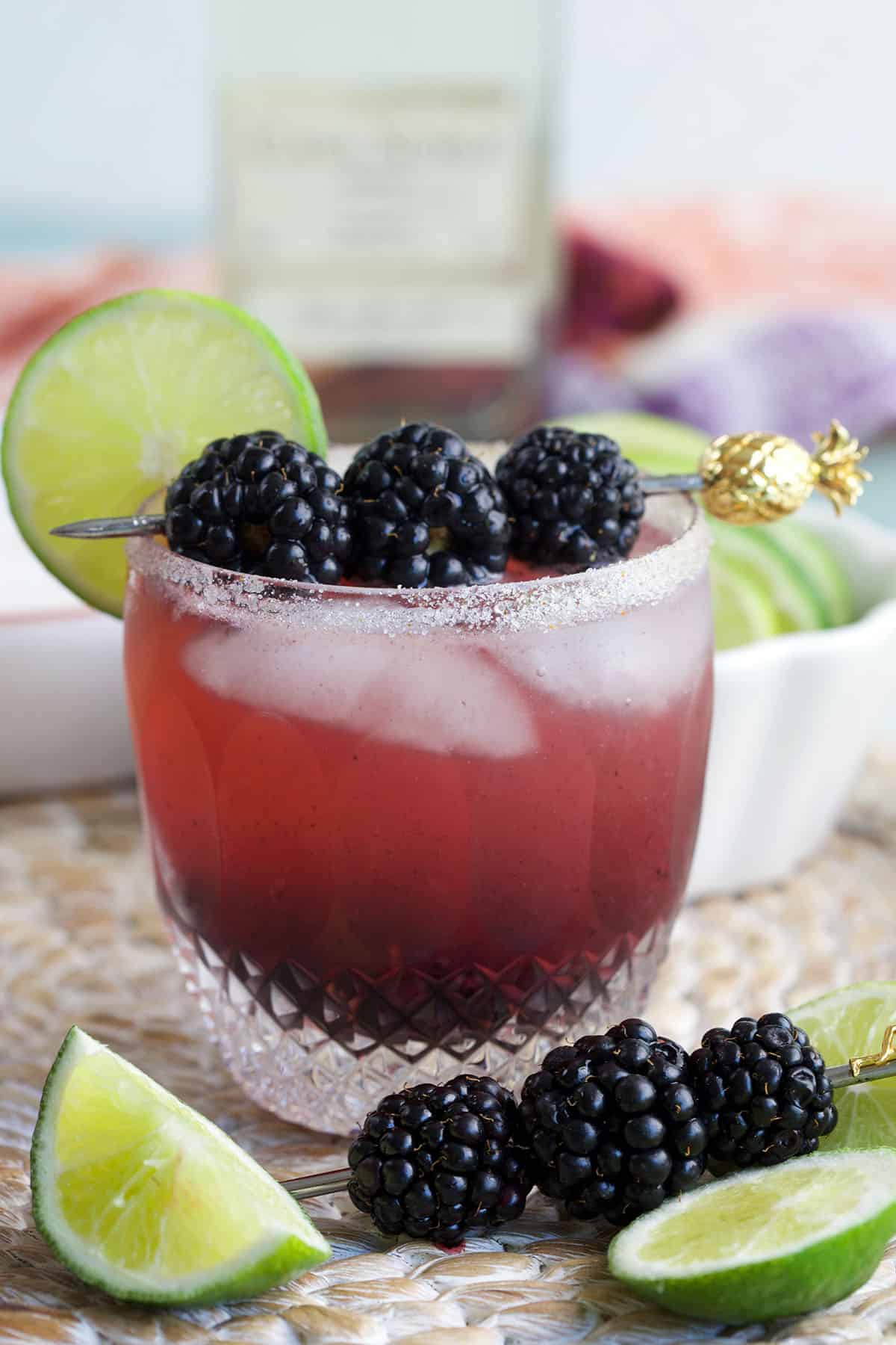 Blackberry margarita in glass with blackberries and lime wheel for garnish