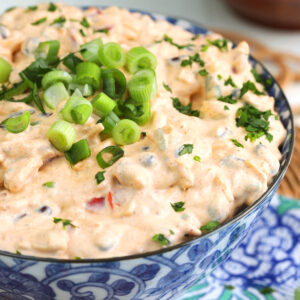 Bowl of boat dip with green onions for garnish