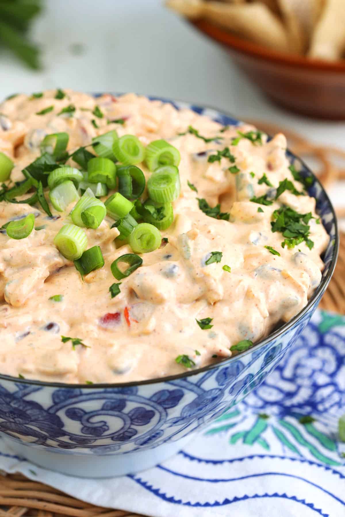 Bowl of boat dip with green onions for garnish