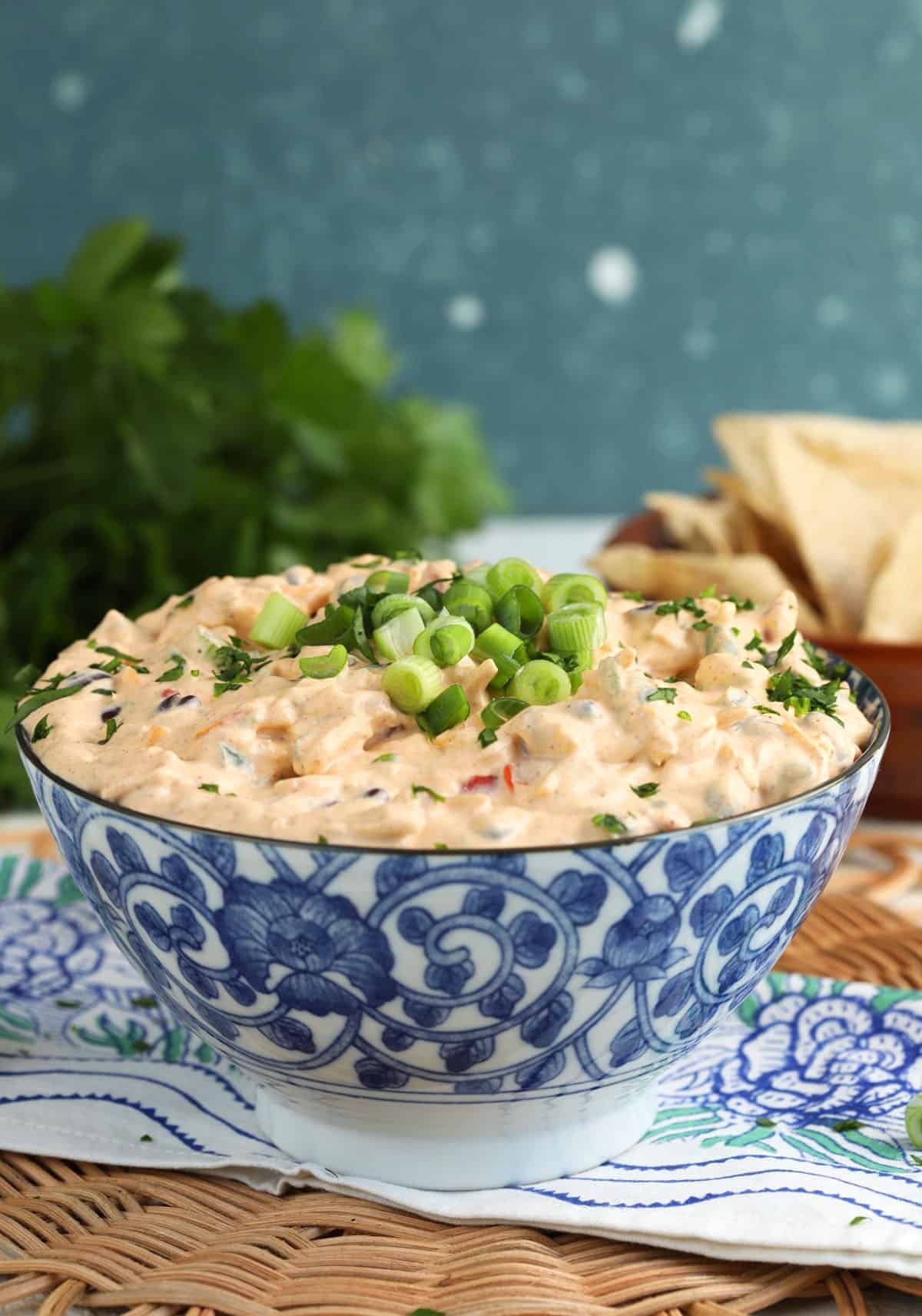 Bowl of boat dip with tortilla chips in background