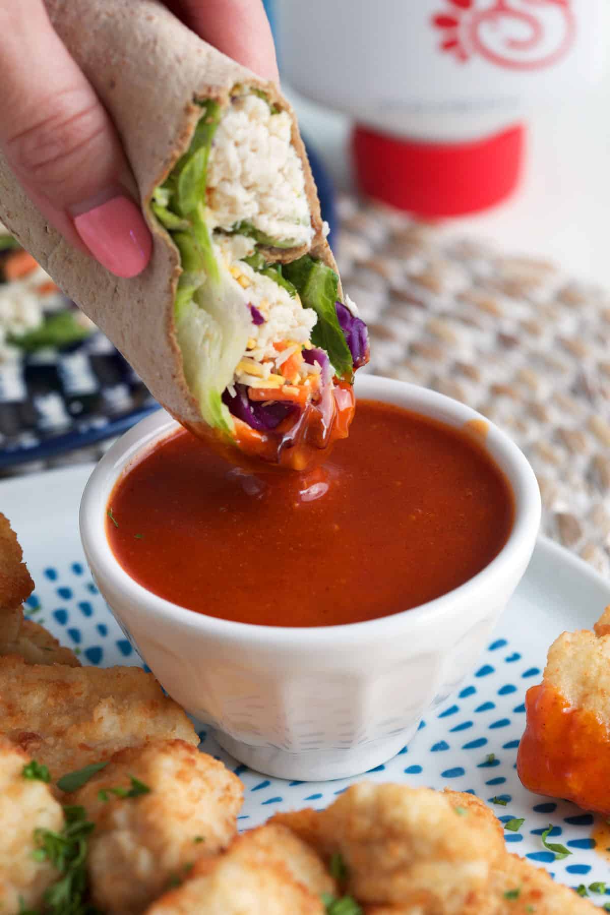 Dipping Chick-fil-A Cool Wrap into sauce