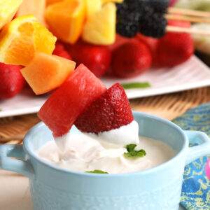 Dipping fruit kabob into Greek yogurt dip