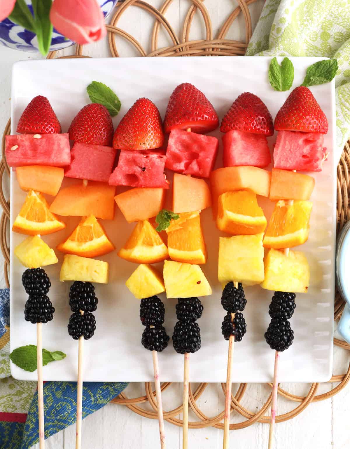 Overhead view of fruit kabobs on platter