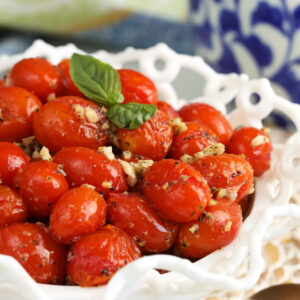 Closeup of roasted cherry tomatoes in serving bowl