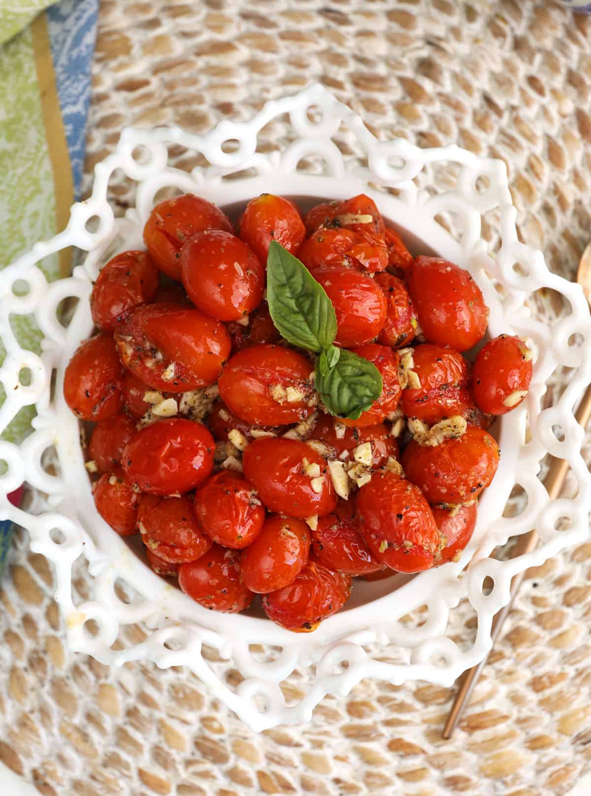 Overhead view of roasted cherry tomatoes in serving bowl