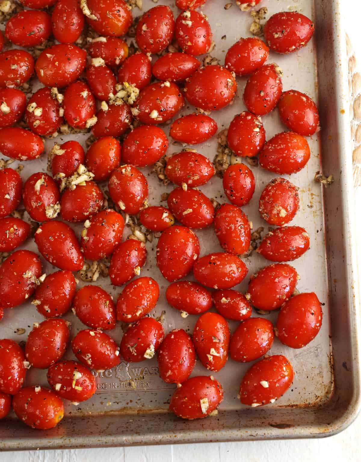 Overhead view of cherry tomatoes on pan before roasting