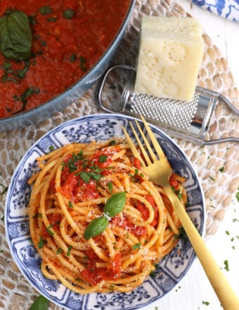 Overhead view of roasted tomato sauce on plate of pasta