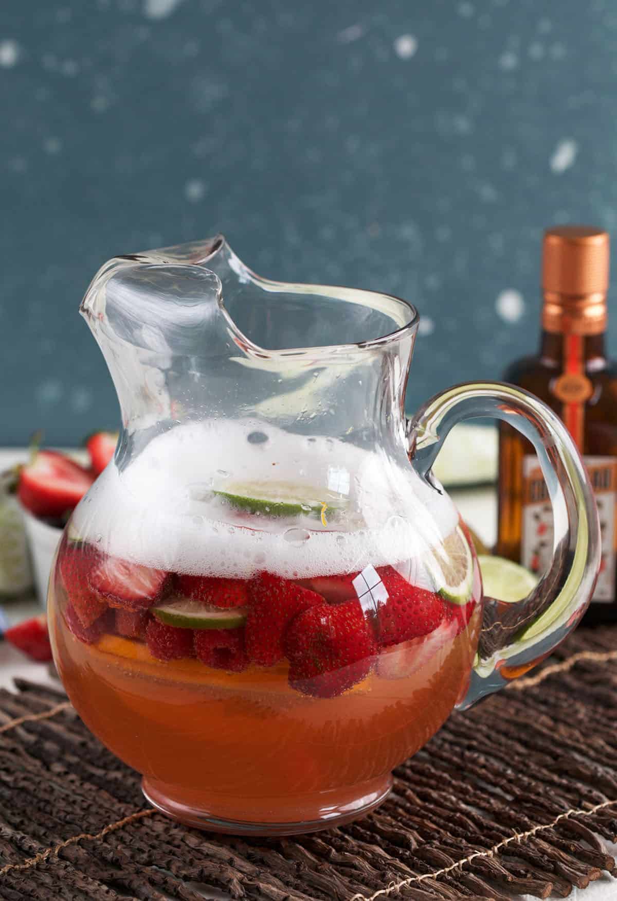 Pitcher of rosé sangria with strawberries and raspberries