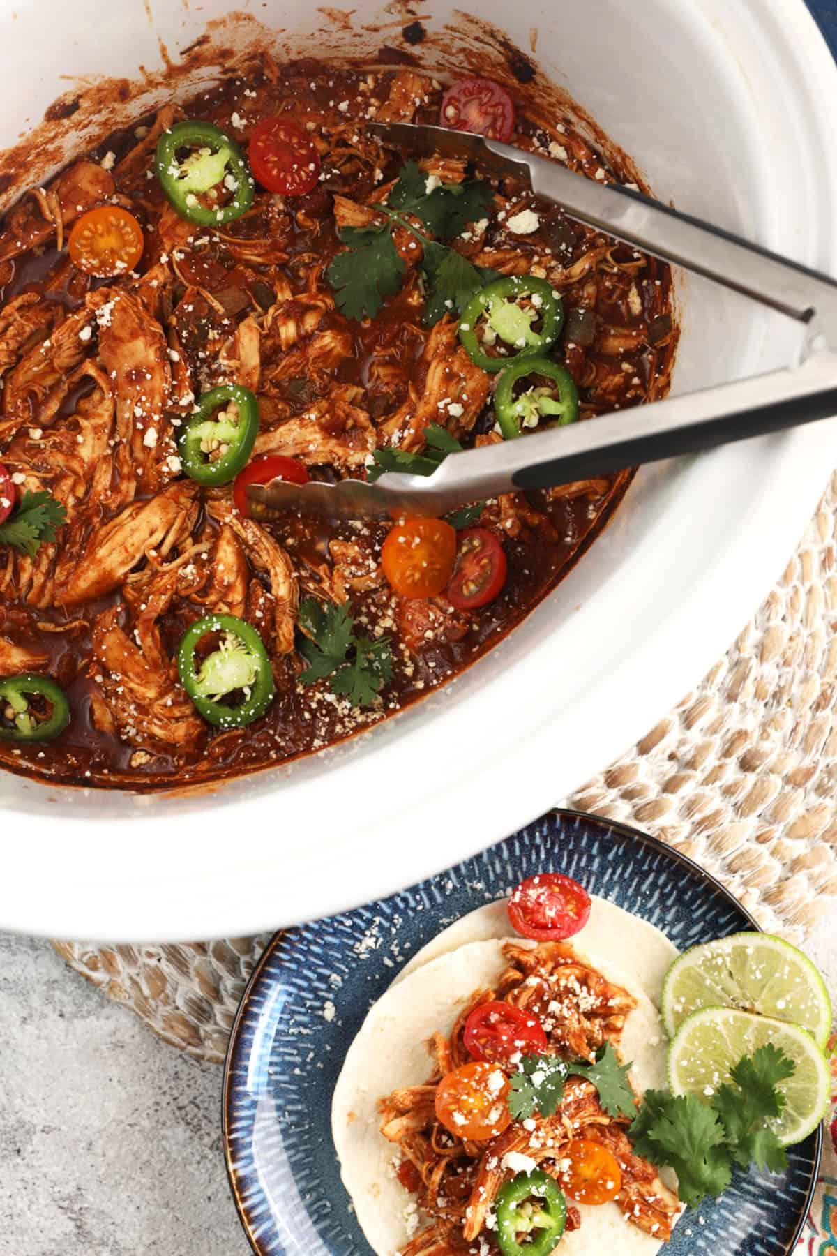 Tongs shredding crockpot salsa chicken