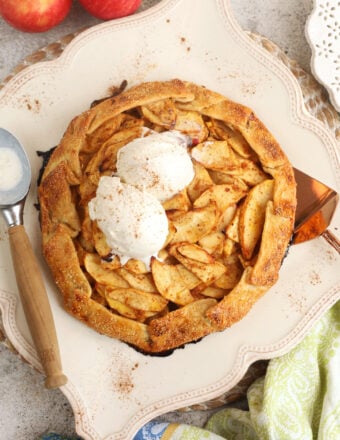 Overhead view of apple galette on platter with ice cream scoops on top