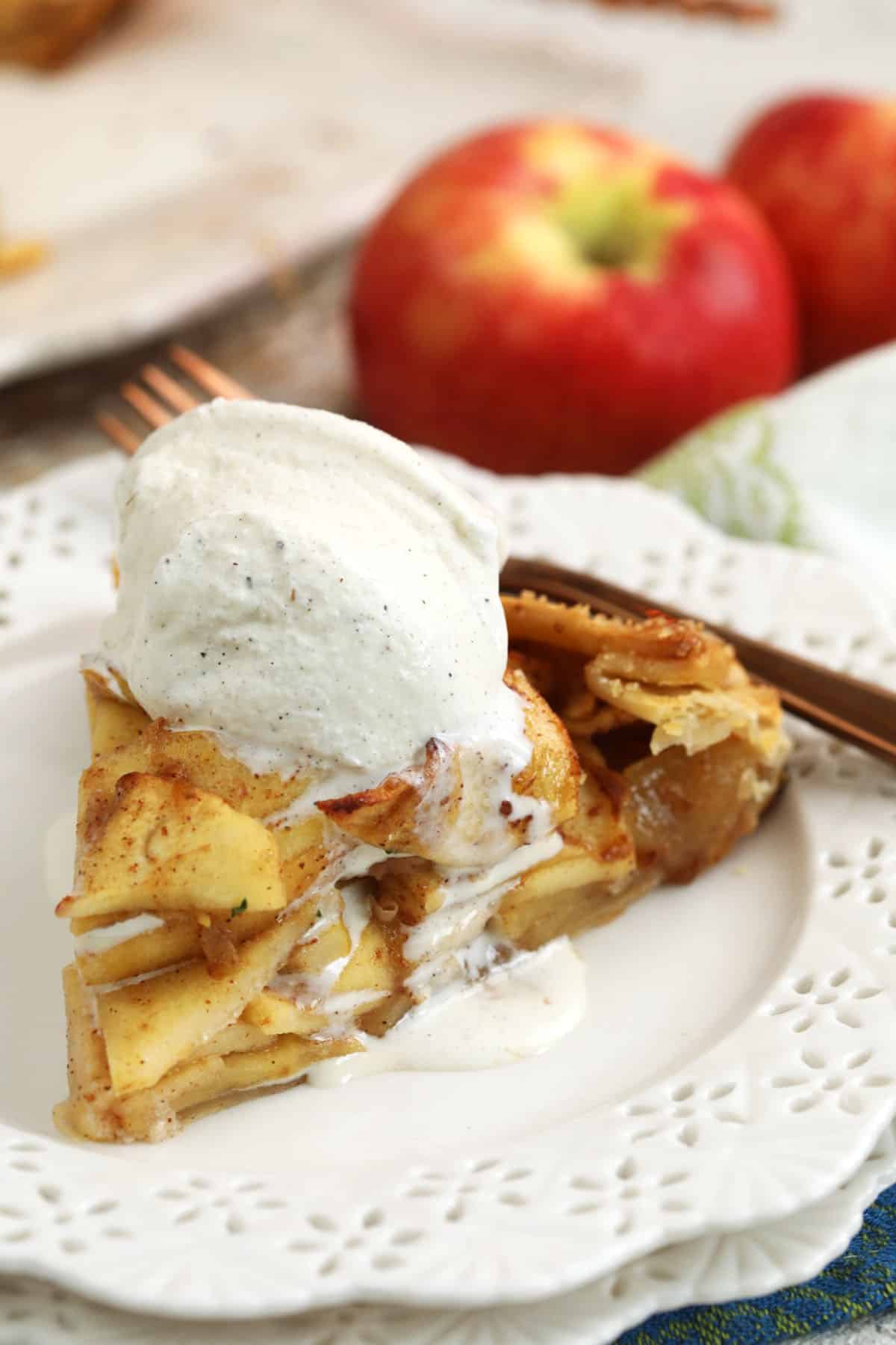 Apple galette on plate with scoop of vanilla ice cream on top