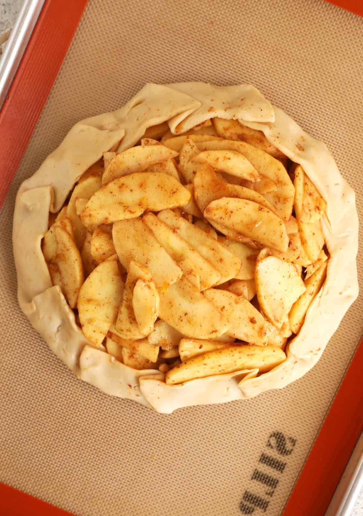 Overhead view of apple galette on pan before baking