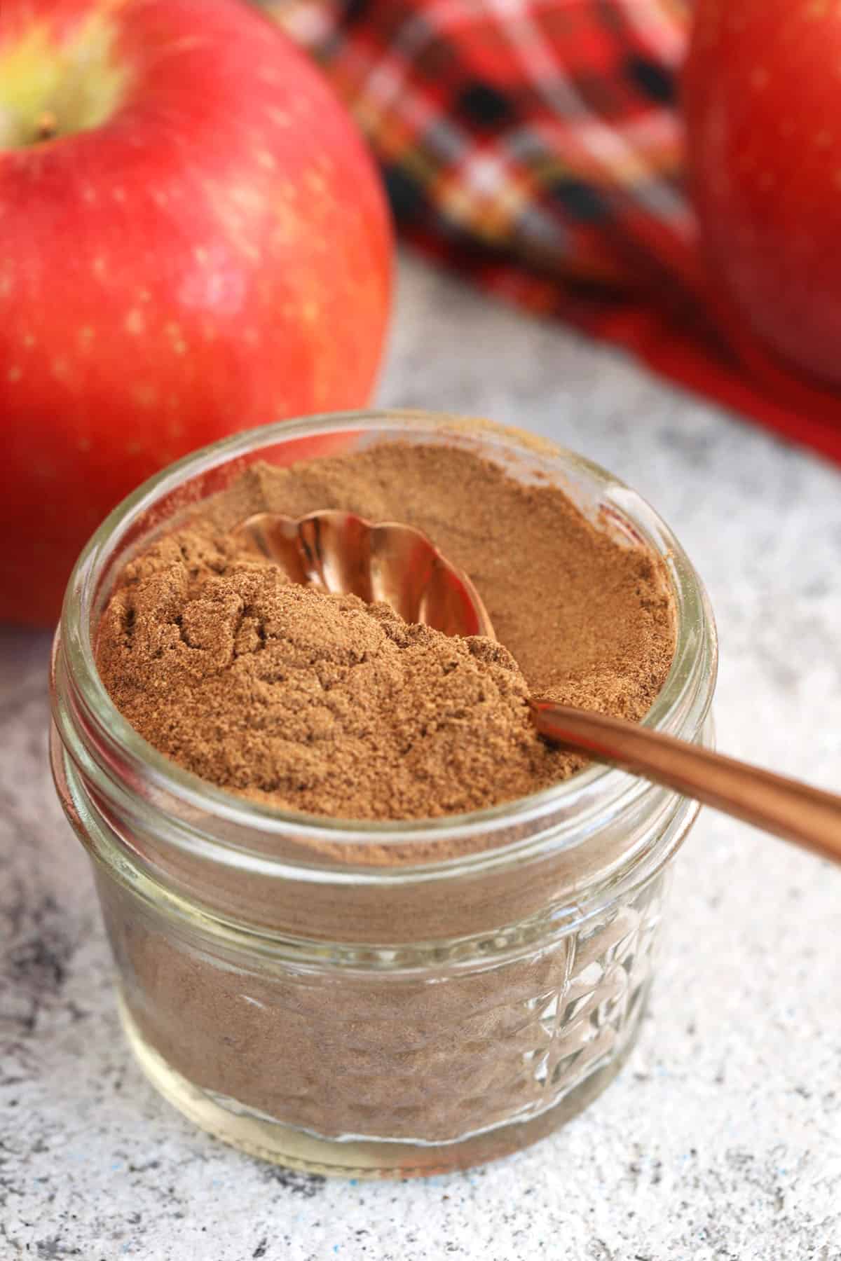 Spoon in jar of apple pie spice