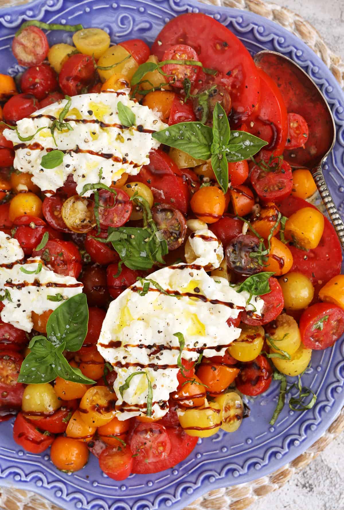 Overhead view of burrata caprese drizzled with balsamic glaze