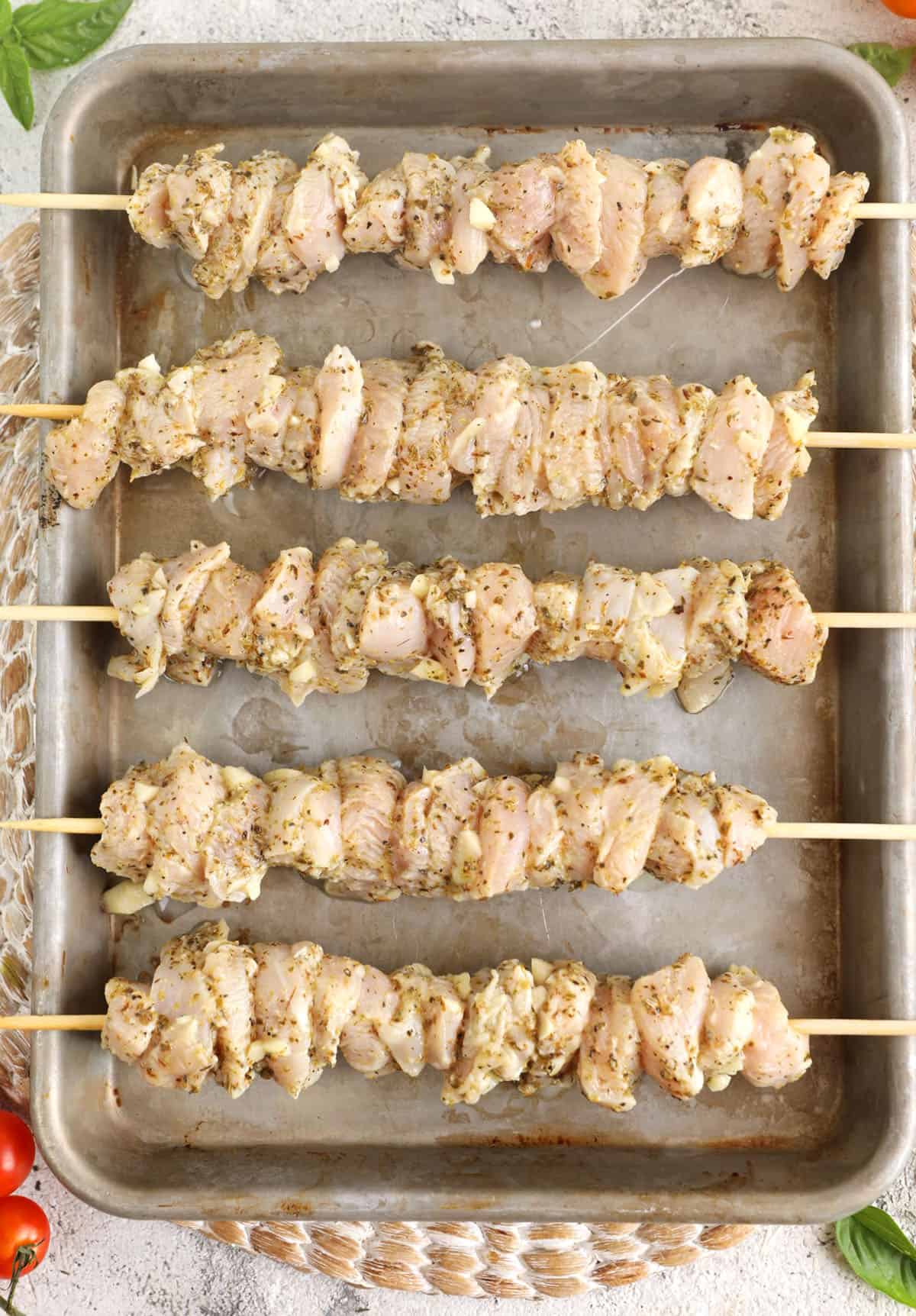 Chicken souvlaki skewers on roasting pan