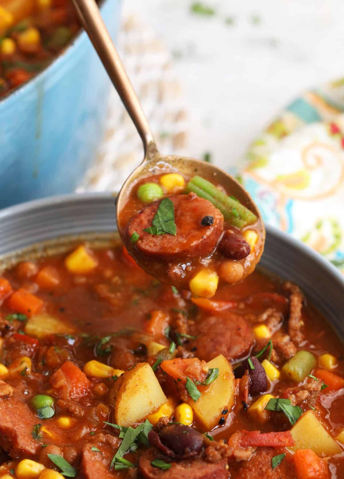 Spoonful of cowboy stew held over bowl