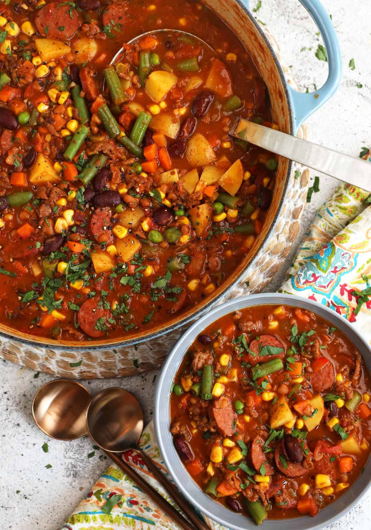 Overhead view of hearty cowboy stew in bowl and pot