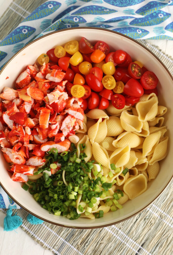 Ingredients for lobster pasta salad in a mixing bowl