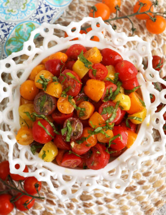 Overhead view of marinated tomatoes in serving bowl