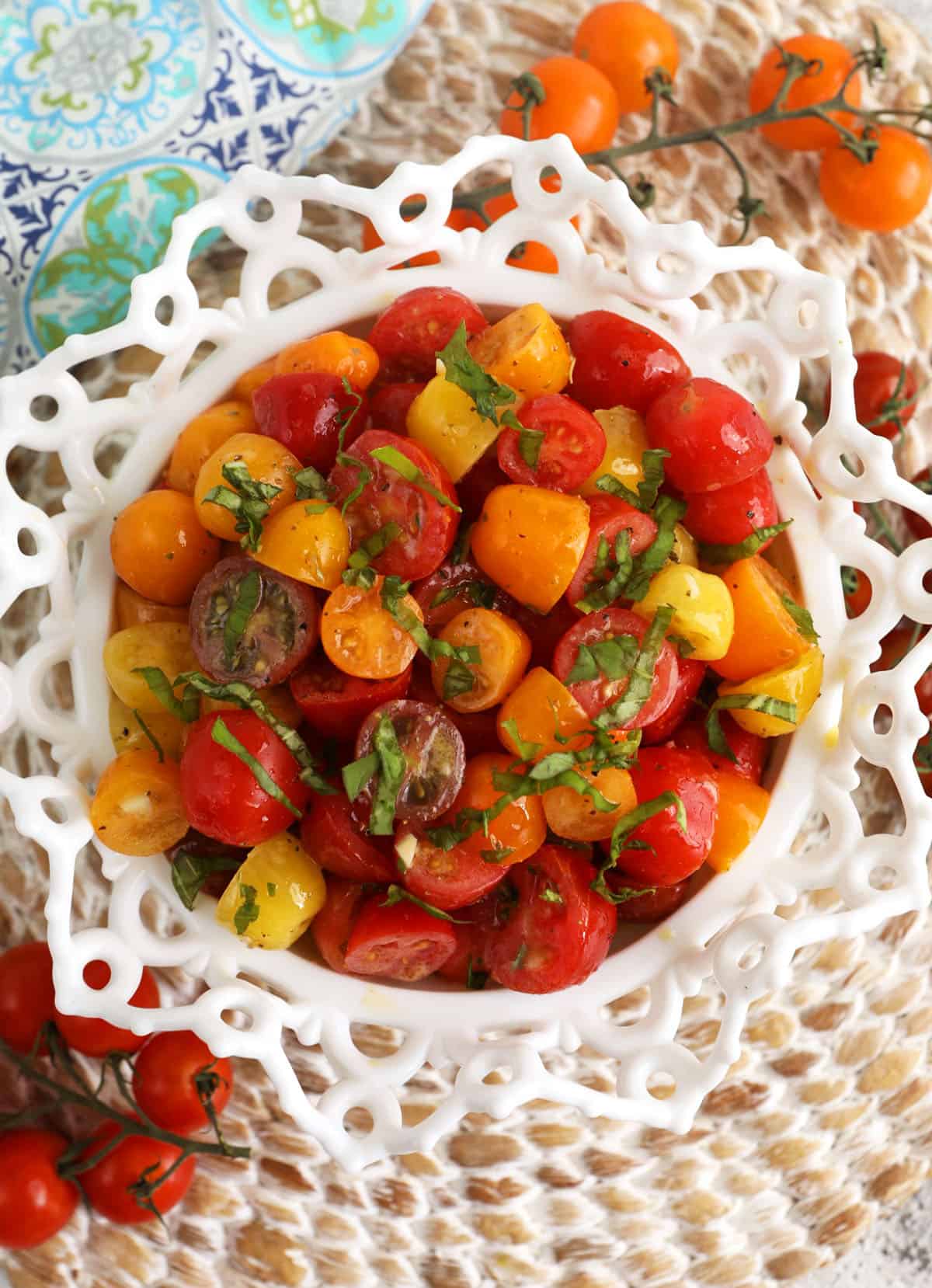 Overhead view of marinated tomatoes in serving bowl