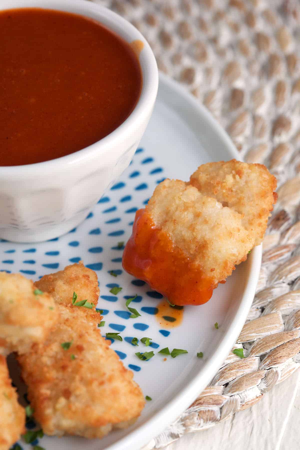 Chicken nugget dipped in homemade Polynesian sauce