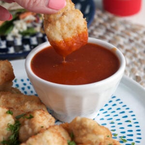 Dipping chicken nugget into homemade Polynesian sauce