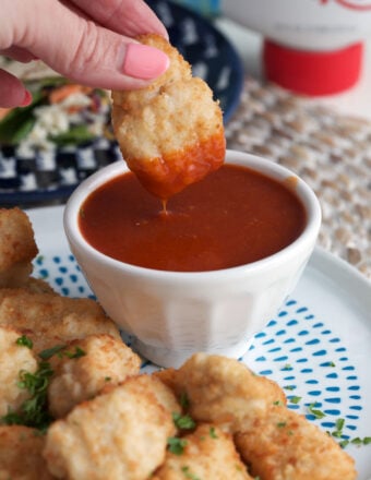 Dipping chicken nugget into homemade Polynesian sauce