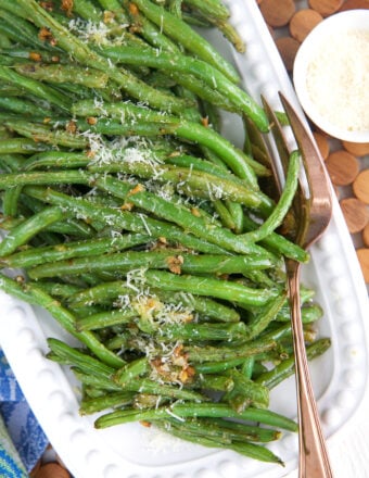 Overhead view of roasted green beans on platter