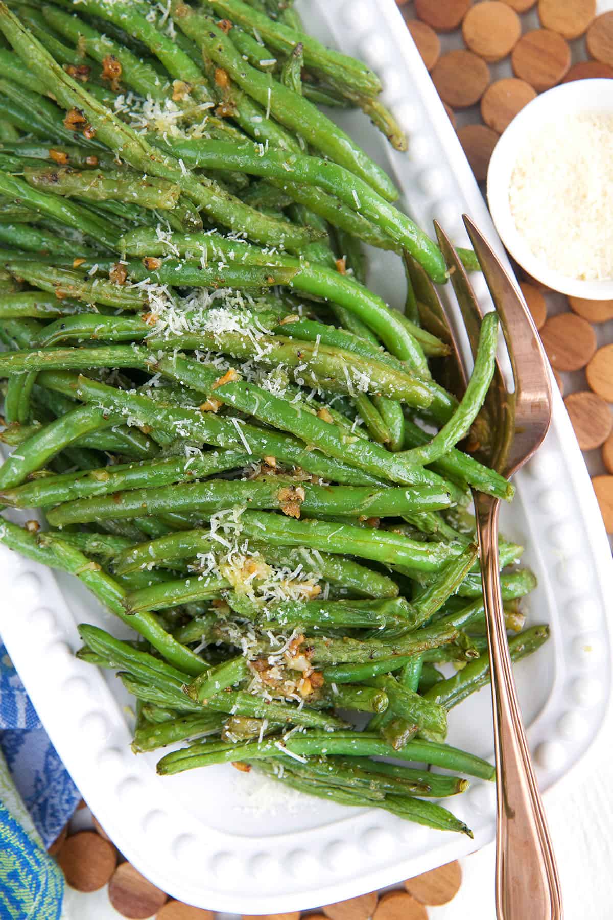 Overhead view of roasted green beans on platter