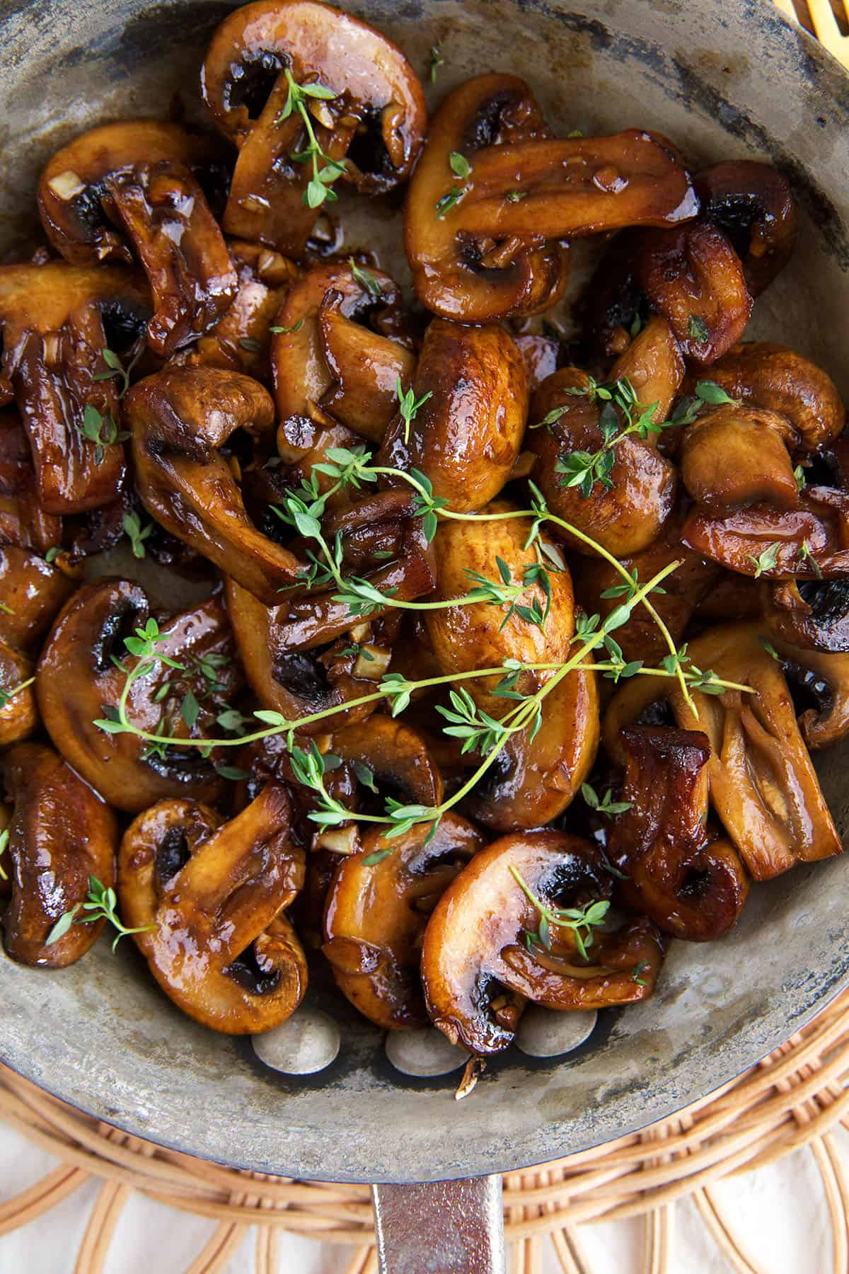 Overhead view of garlic butter sauteed mushrooms in skillet