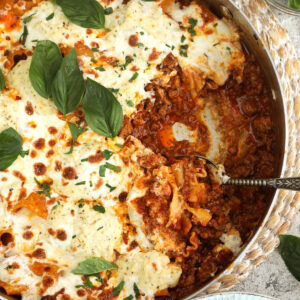 Overhead view of skillet lasagna with portion removed