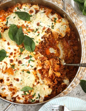 Overhead view of skillet lasagna with portion removed