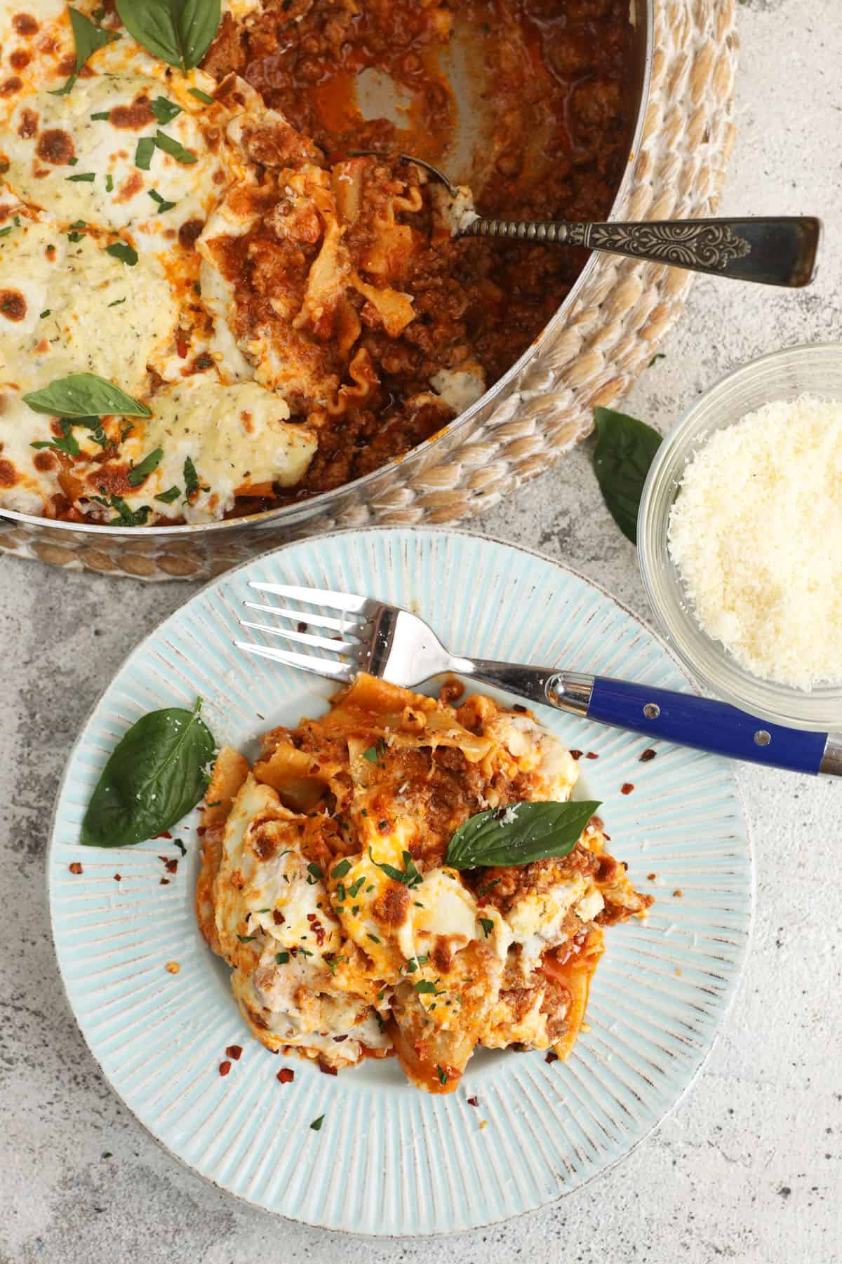 Overhead view of skillet lasagna on plate and in pan