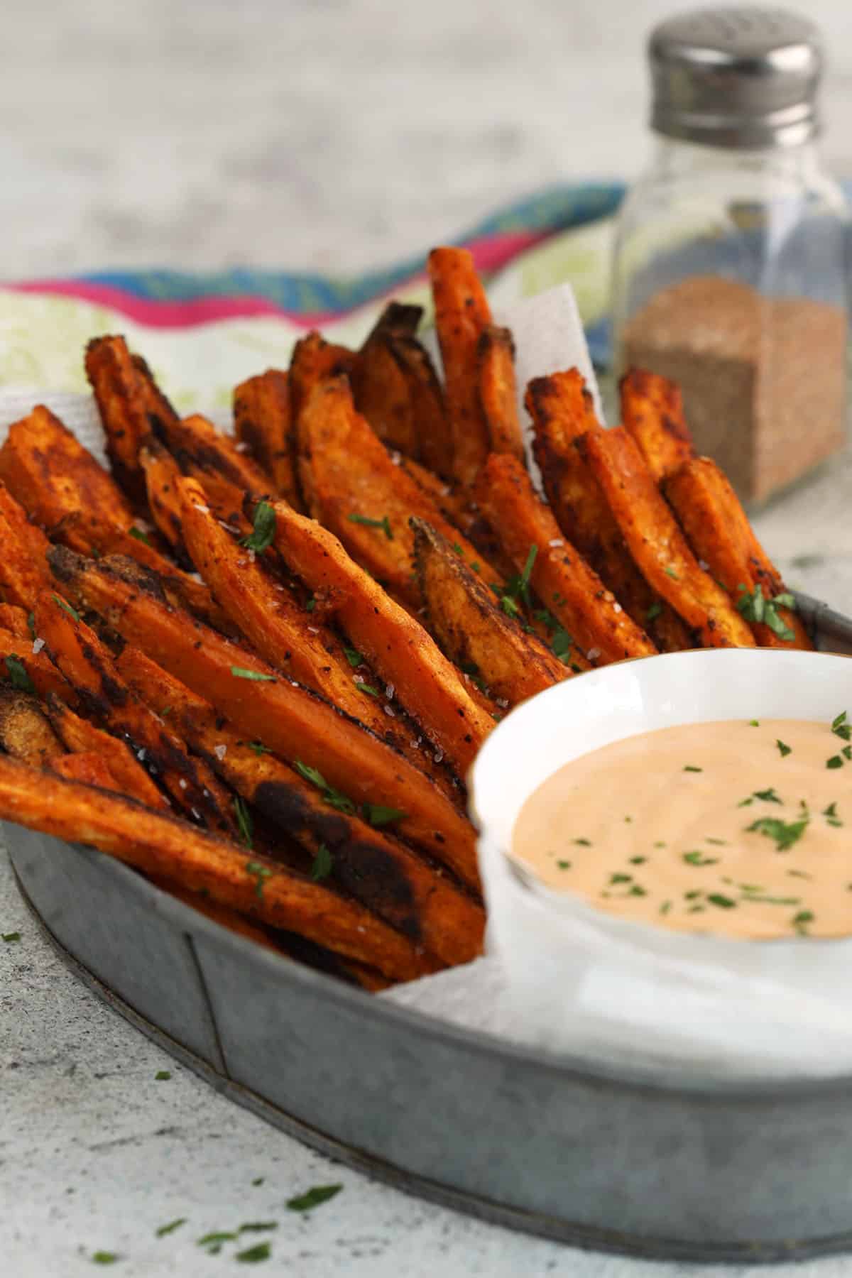 Crispy baked sweet potato fries with bowl of dipping sauce