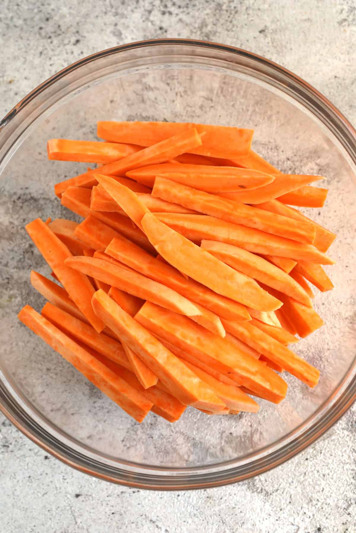 Sweet potato fries tossed in oil