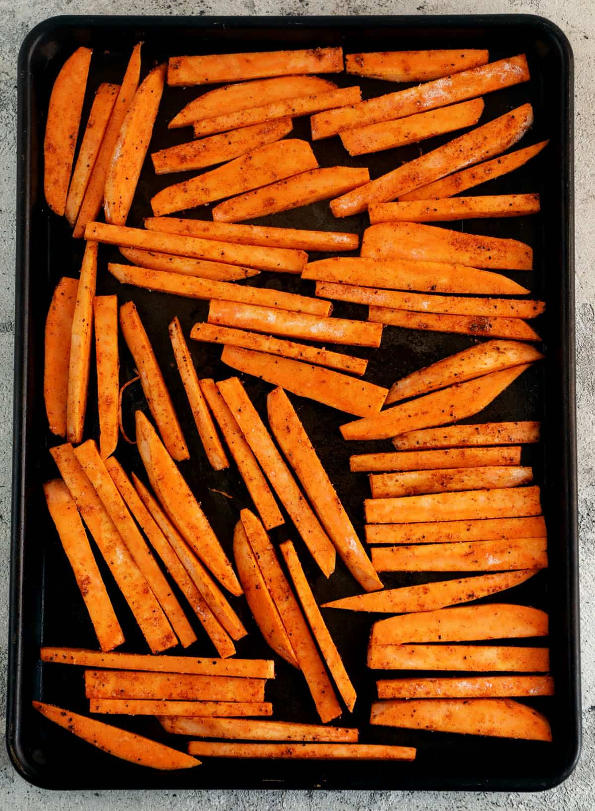 Overhead view of sweet potato fries on sheet pan