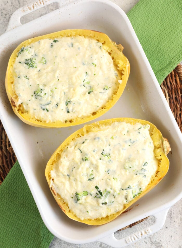 Overhead view of spaghetti squash alfredo mixture stuffed into squash shells