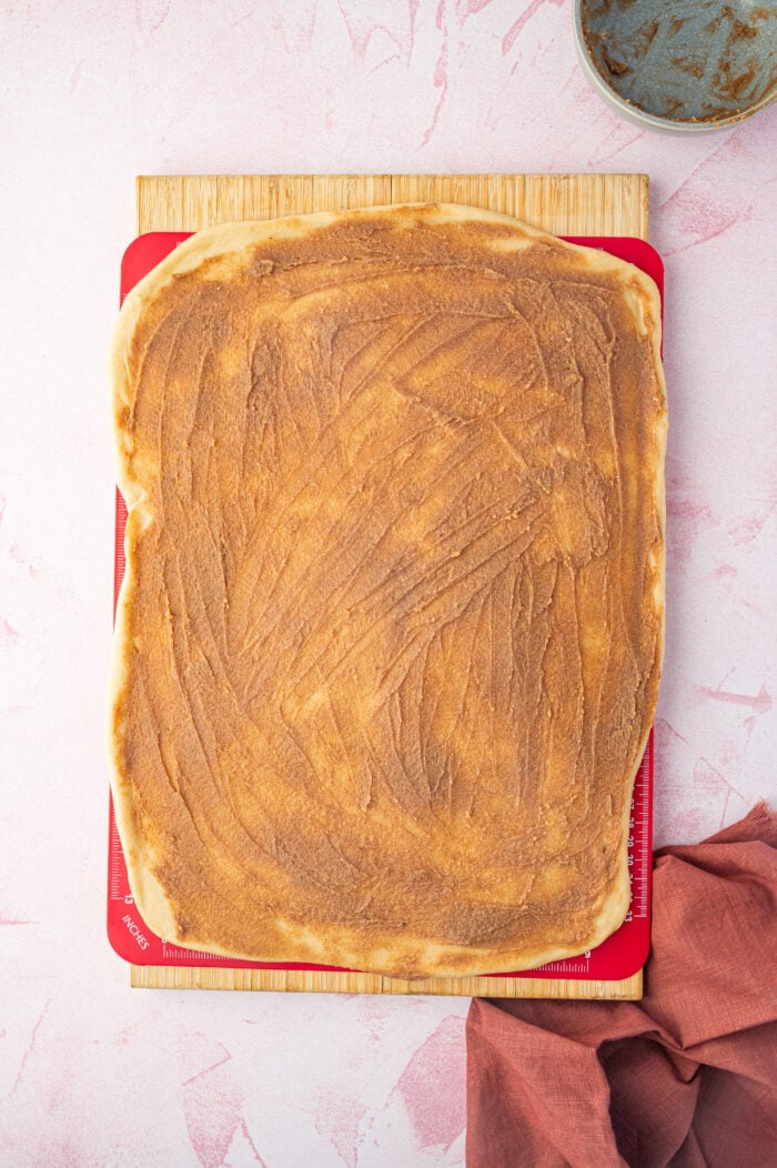 Cinnamon topping spread onto babka dough