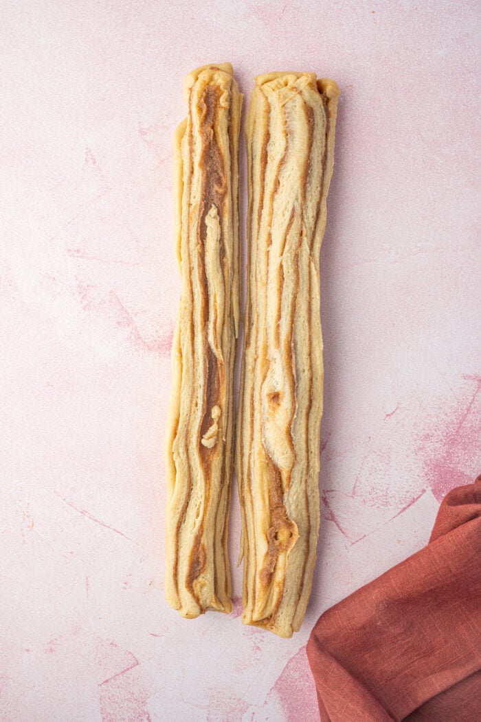 Two halves of cinnamon babka dough after slicing