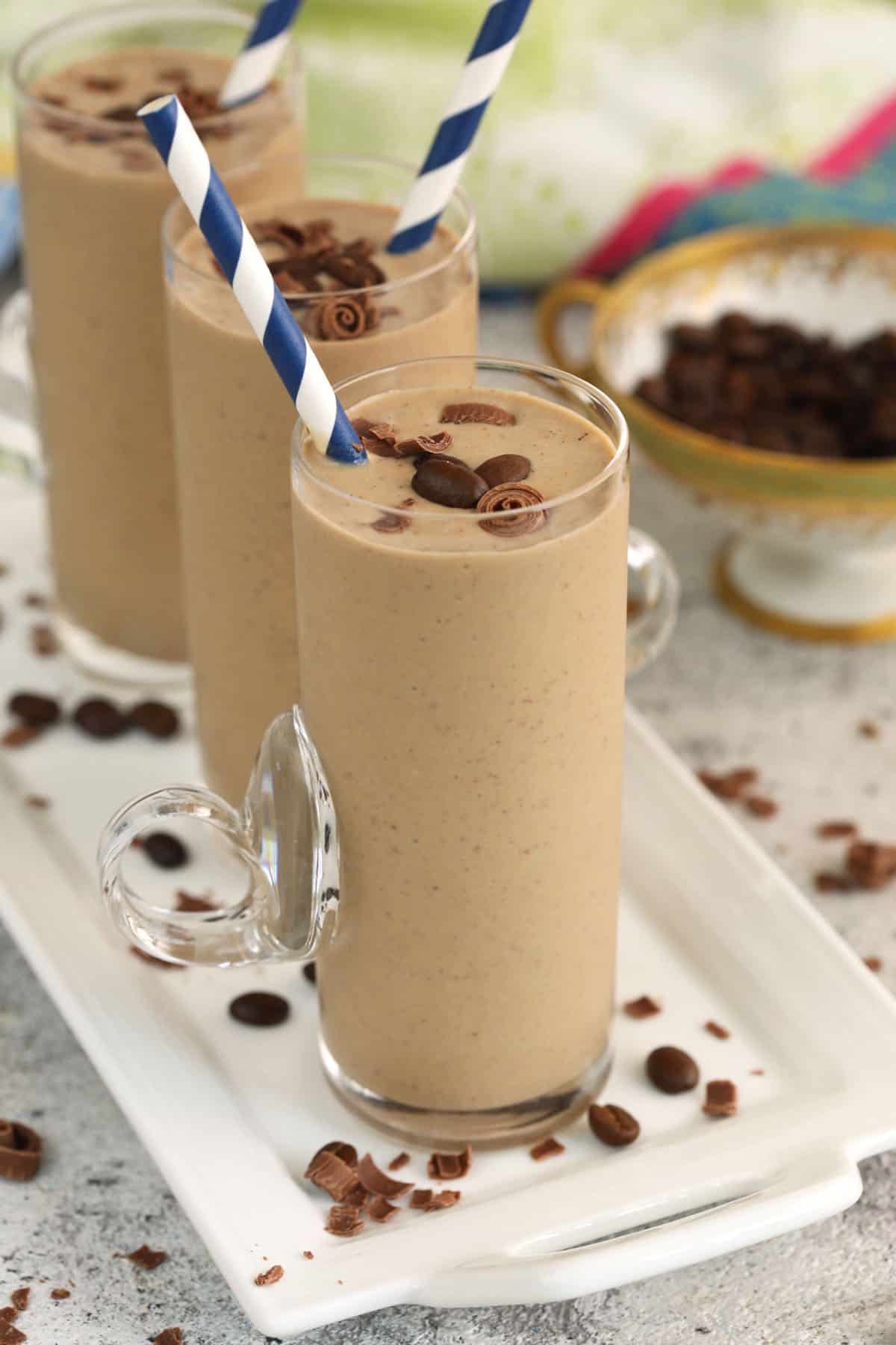 Three coffee smoothies lined up on platter