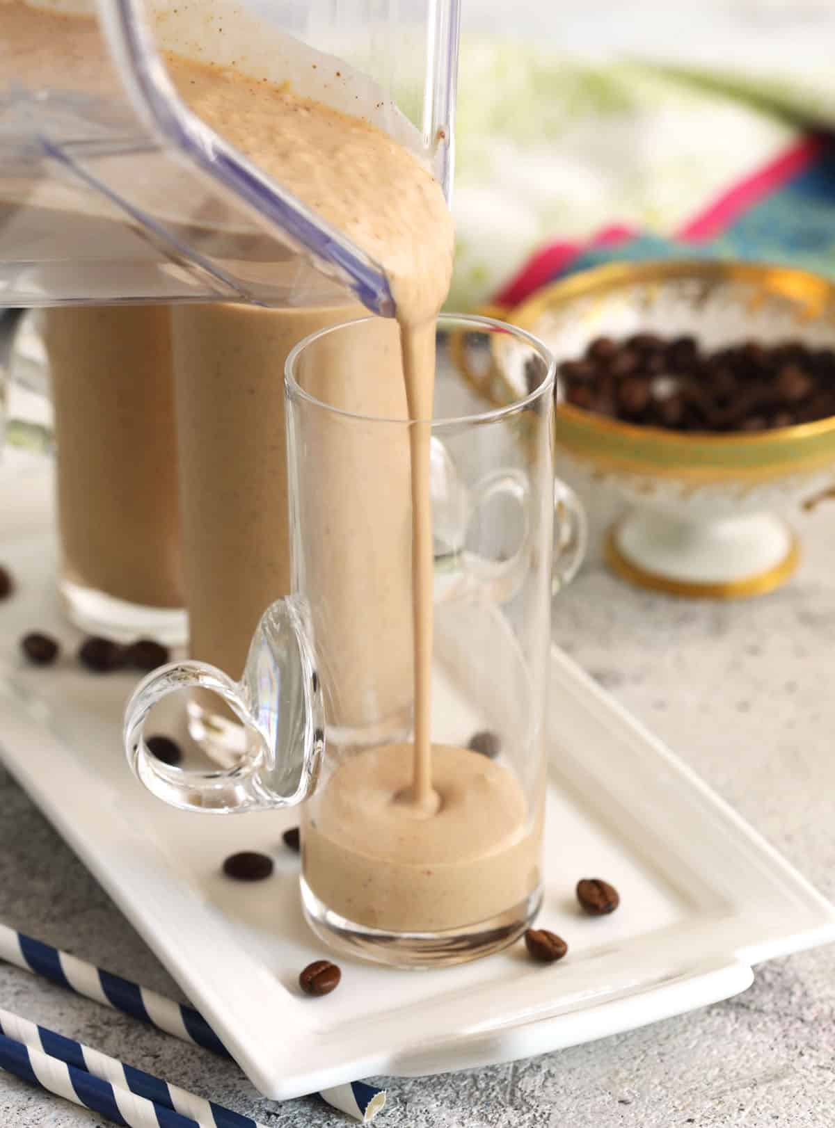 Pouring coffee smoothie into glass