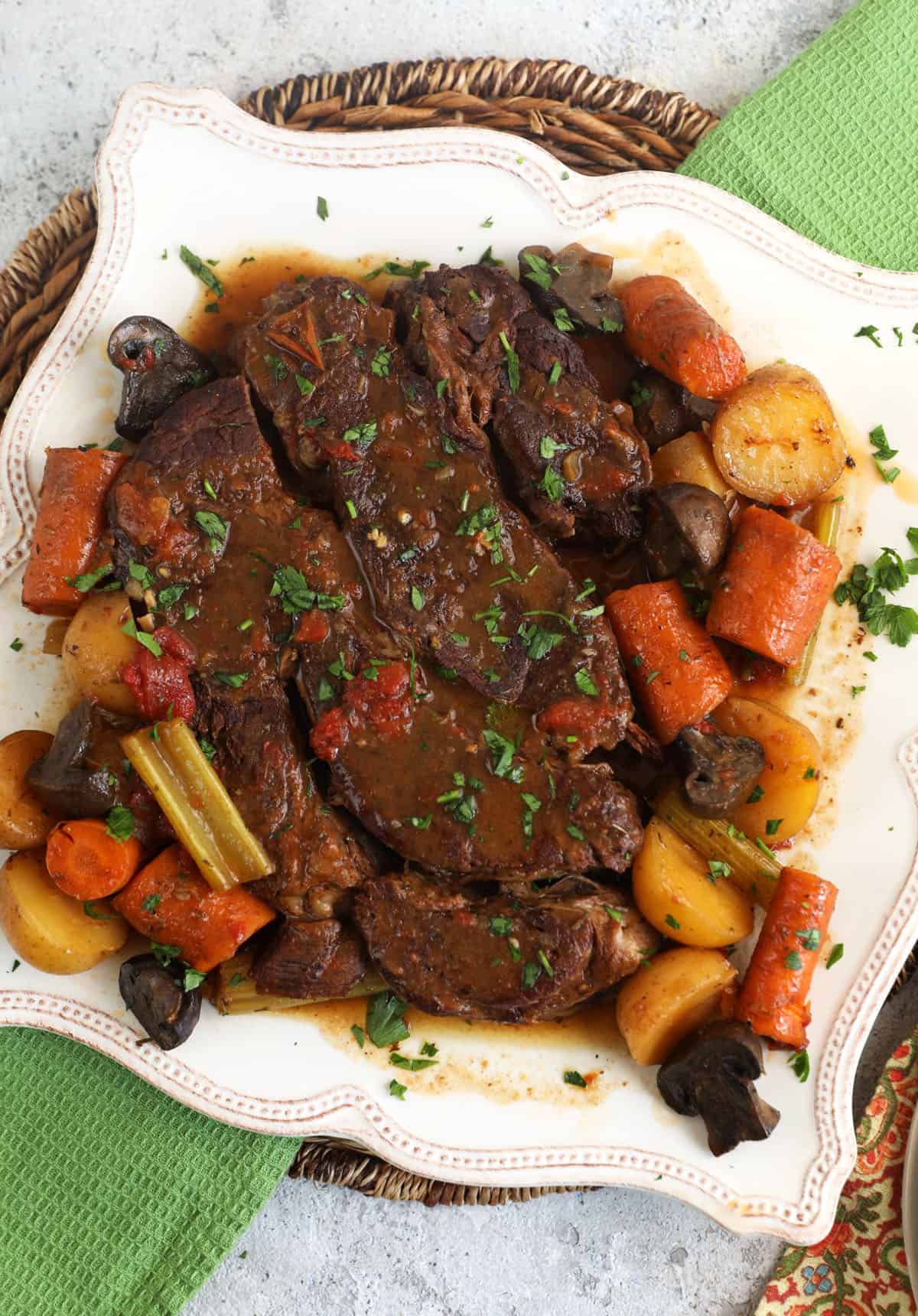 Overhead view of slow cooker pot roast on platter with vegetables