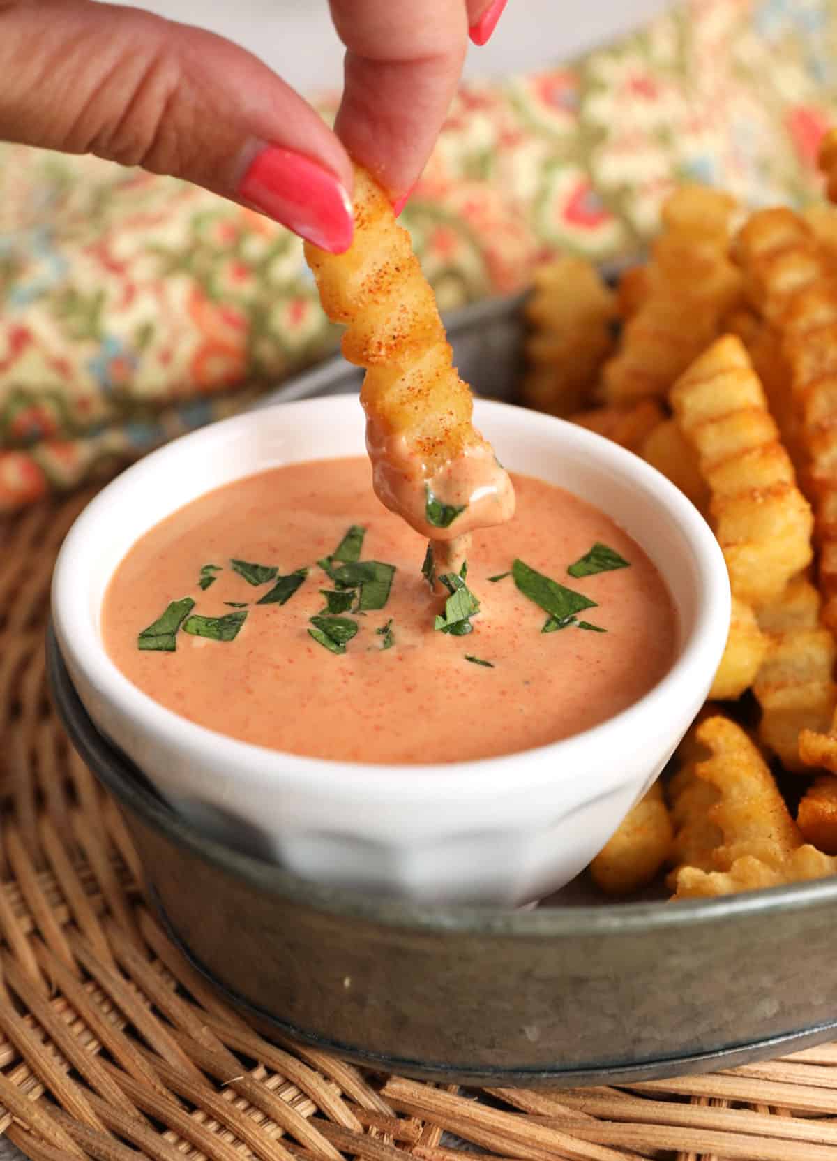 Dipping fry in French fry sauce