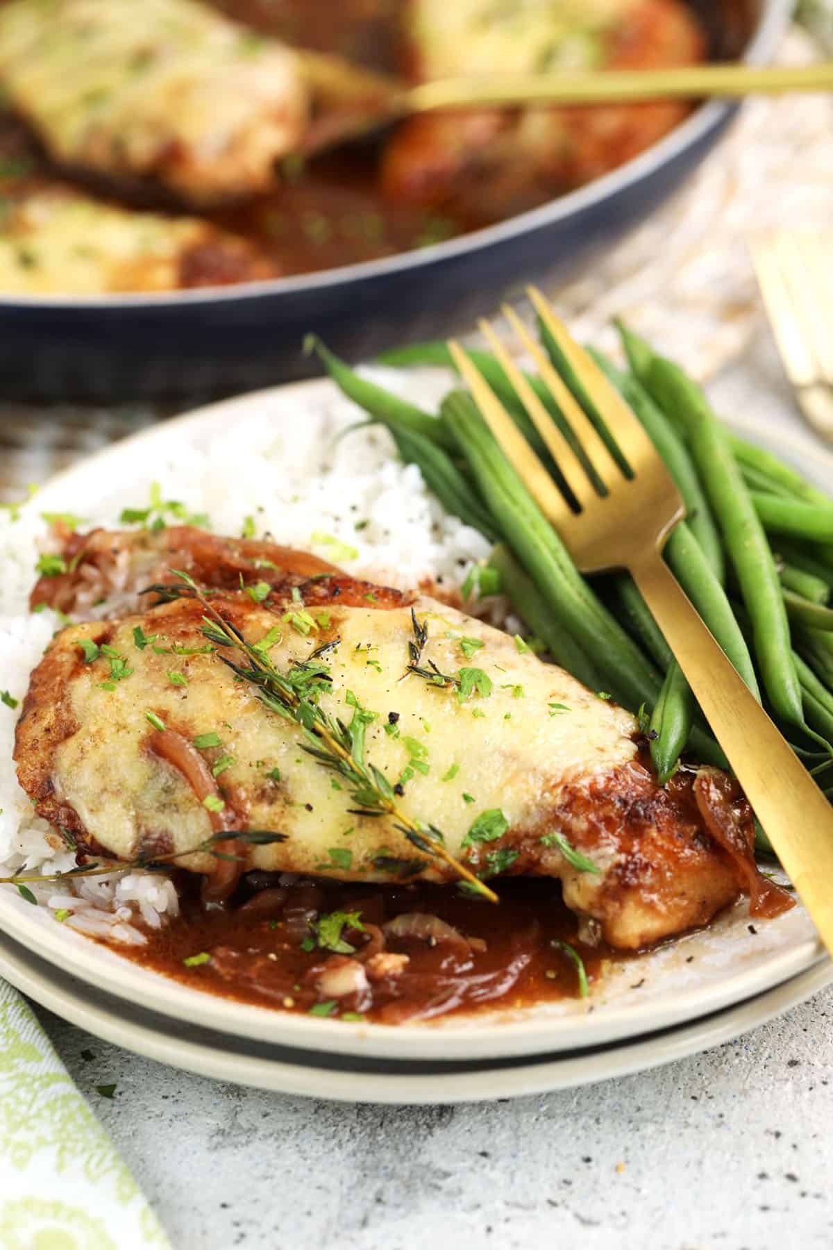 French onion chicken on plate with green beans