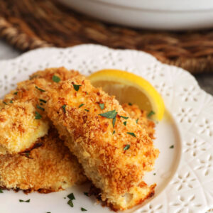 Fish sticks on plate with lemon wedges